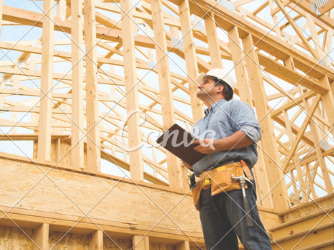 Contractor reviewing drawings on site during construction